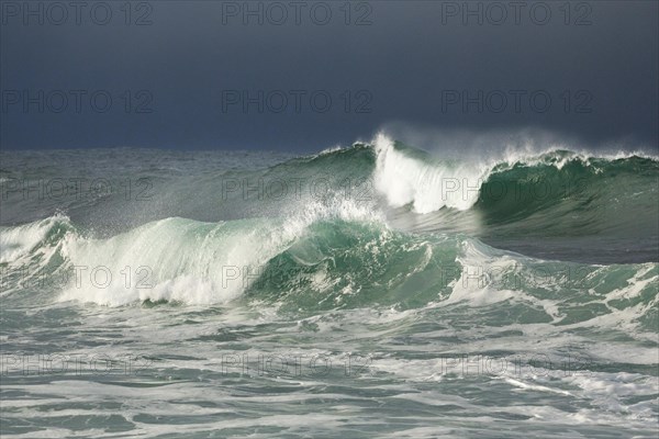 Big waves crashing in the open sea and dramatic light off the north coast of Ireland