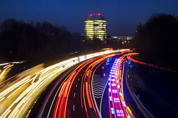 Light trails on the A 52 motorway and the E.ON SE corporate headquarters in the evening