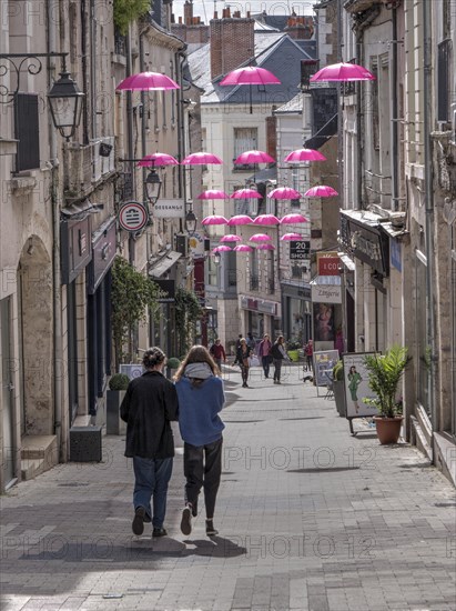 Pink umbrellas in the air