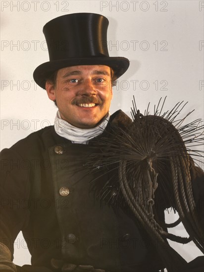 Chimney sweep in professional training and posing in a photo studio