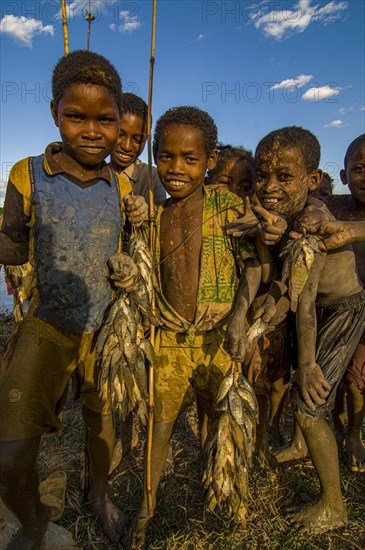 Young boys with their fresh caught fish