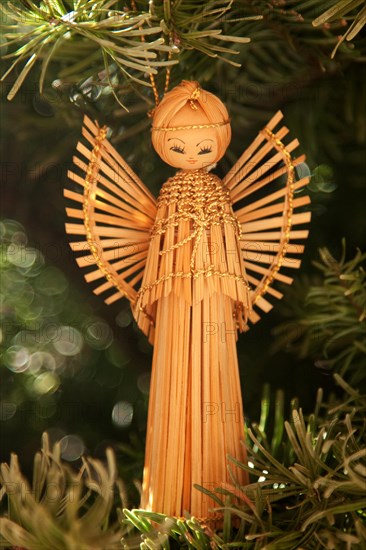 Angel ornament hanging from Christmas tree