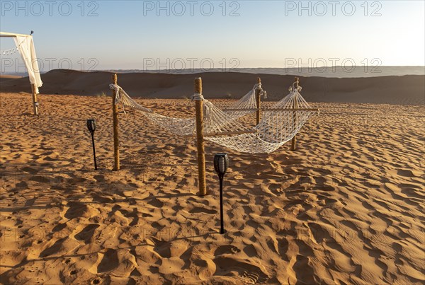 Two hammocks in desert camp