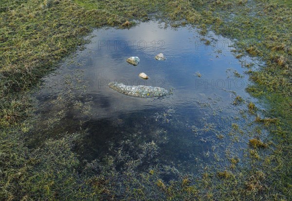 A natural smiley made of stones in the middle of a puddle of water in the Highlands of Scotland