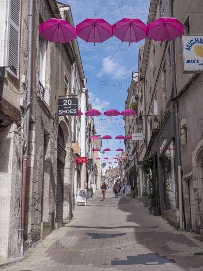 Pink umbrellas in the air