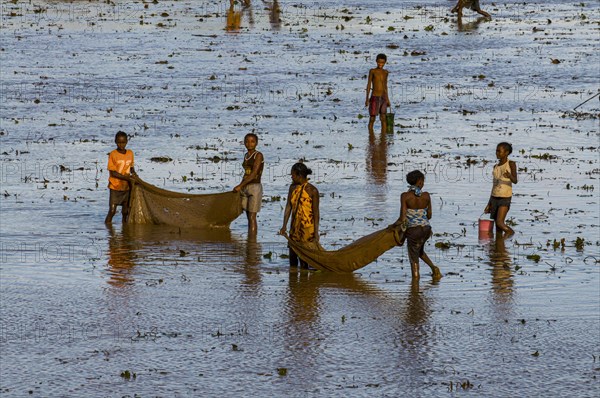 Locals fishing in a shallow lake