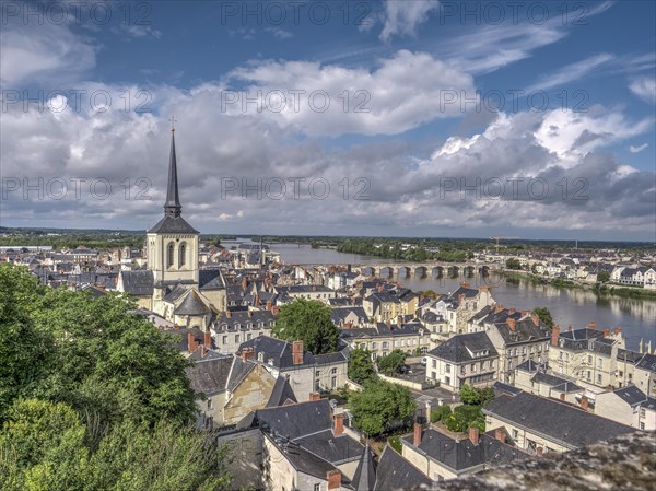 Panorama of the town of Saumur with the dominating bell tower of the Eglise Saint-Pierre-du-Marais and the Loire with the old bridge Pont Cessart