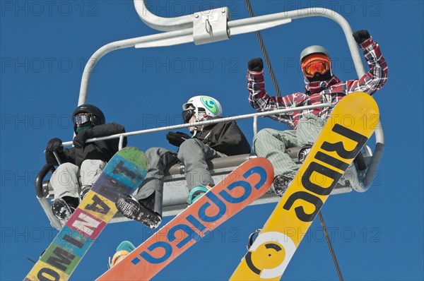 Snowboarders on a ski lift