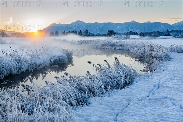 Snowy winter landscape with the Uffinger Ach at sunrise with Herzogstand 1731m and Heimgarten 1790m