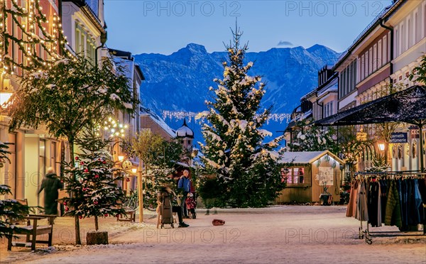 Winter Obermarkt in the snow with Christmas tree and Christmas lights in front of the Hoehen Kiste 1922m in the Estergebirge