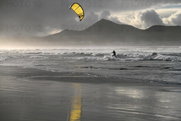 Kitesurfers at sunset on the beach of Caleta de Famara