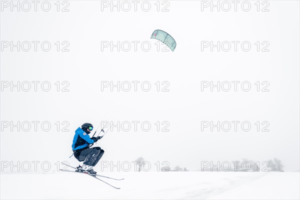 Kite surfers in wintry landscape