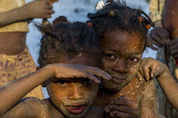 Dirty kids in a shallow lake