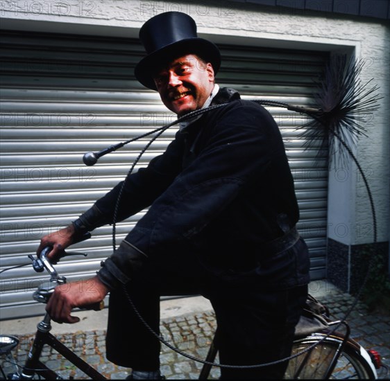 Chimney sweep in professional training and posing in a photo studio