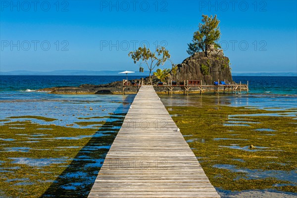Pier to little islet on the coastline of the Island Ile Sainte Marie