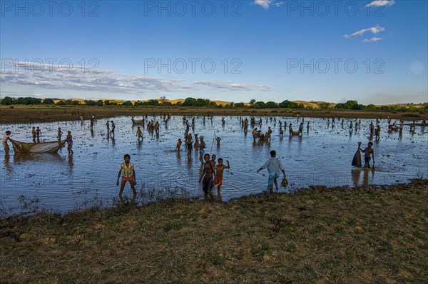 Locals fishing in a shallow lake