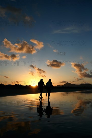 Sunset reflected on Caleta de Famara beach