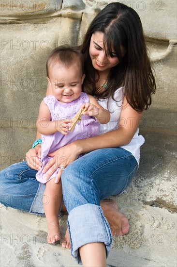 Young mother with infant at the beach