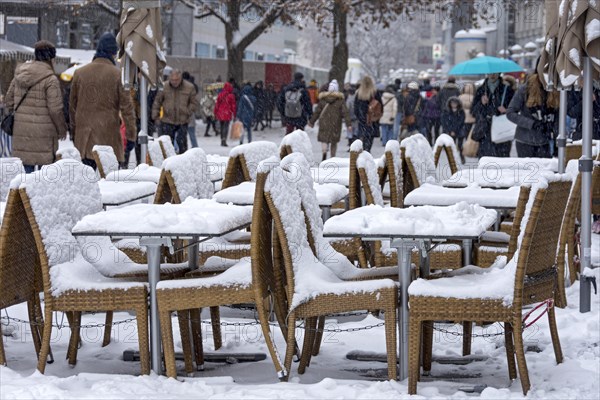 Snow-covered tables and chairs