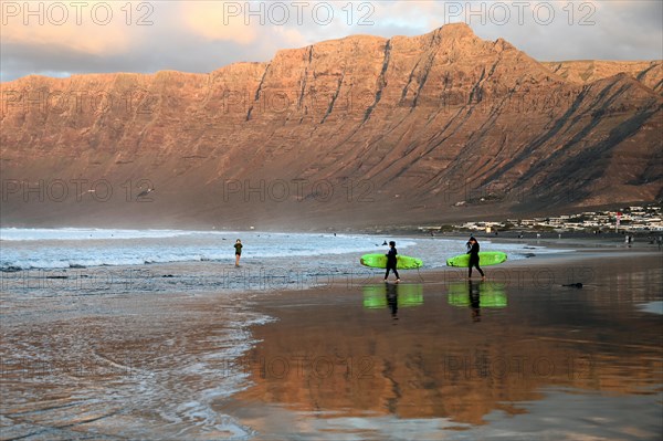Surfers on the beach of Caleta de Famara