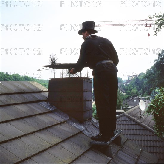 Chimney sweep in professional training and posing in a photo studio