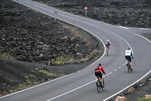 Road cyclist on the road through Timanfaya National Park