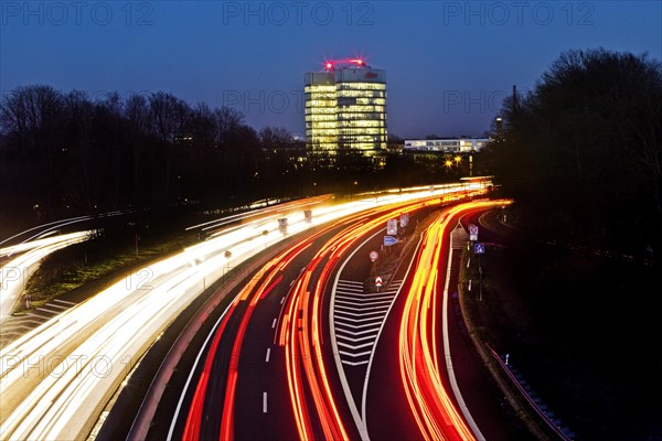 Light trails on the A 52 motorway and the E.ON SE corporate headquarters in the evening