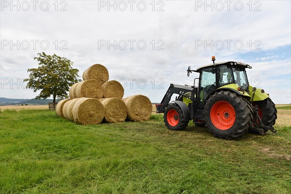 Tractor with bale fork stacking round bales