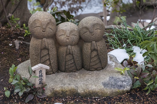 Three small stone buddhas