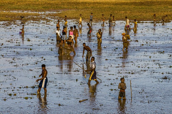 Locals fishing in a shallow lake