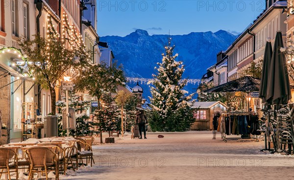 Winter Obermarkt in the snow with Christmas tree and Christmas lights in front of the Hoehen Kiste 1922m in the Estergebirge