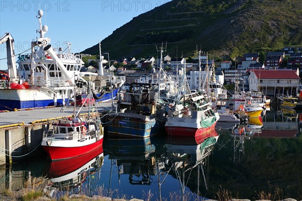 Harbour with small fishing boats reflected in the calm water