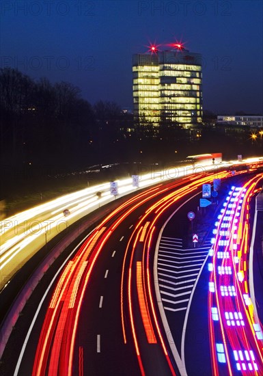 Light trails on the A 52 motorway and the E.ON SE corporate headquarters in the evening
