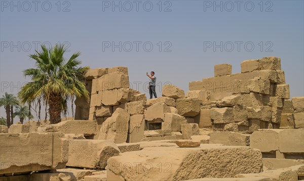 Tourist climbing temple ruins
