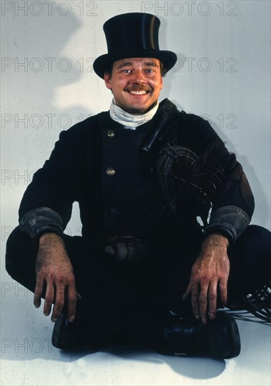 Chimney sweep in professional training and posing in a photo studio