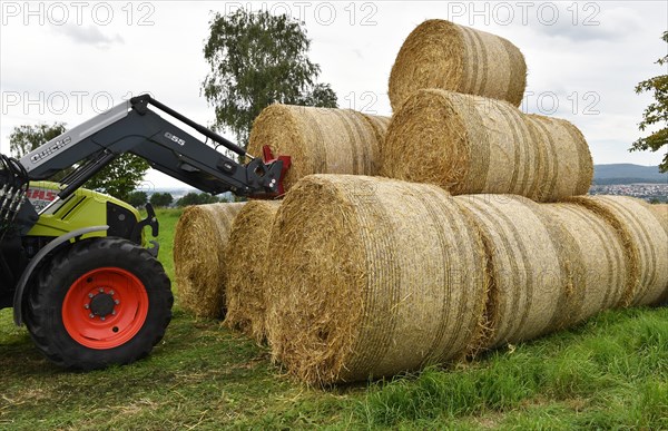 Tractor with bale fork stacking round bales