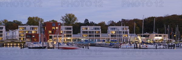 Marina and illuminated modern buildings