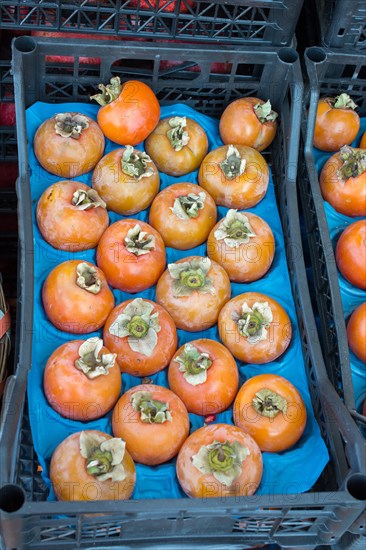 Persimmons in Turkish street bazaar in view