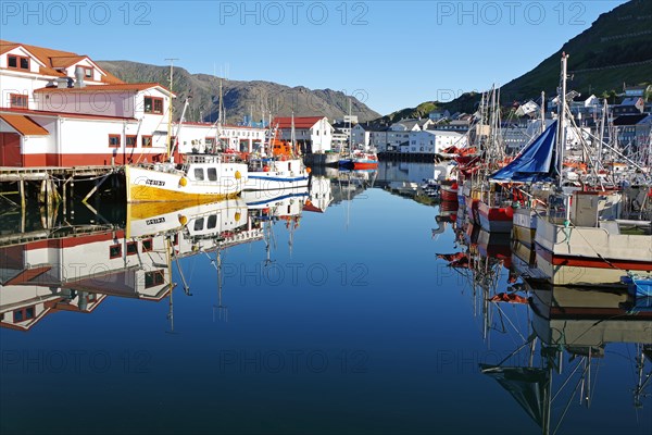Harbour with small fishing boats reflected in the calm water