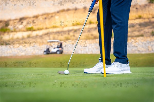 Playing golf at golf club on the green