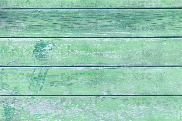 Wooden background with green colored planks