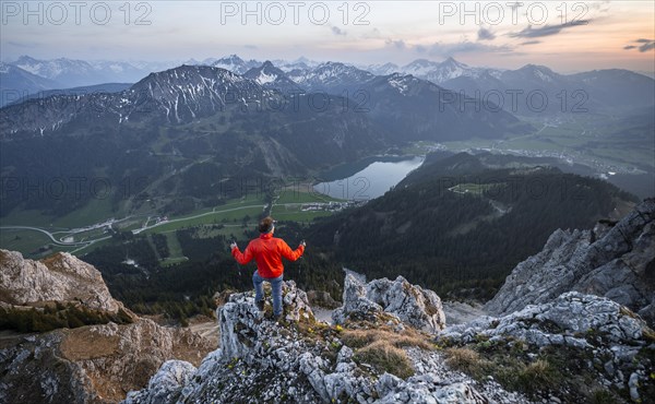 Hiker at the summit of Schartschrofen at sunset