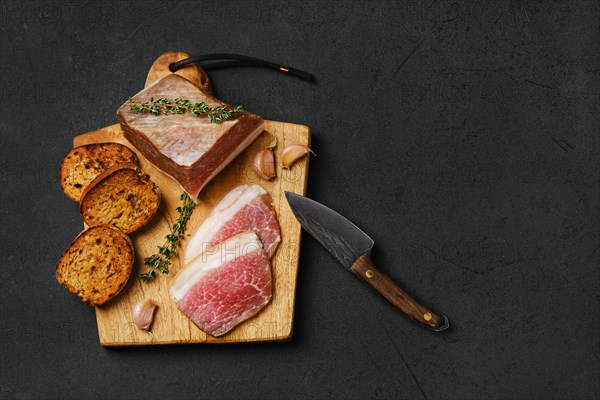 Top view of salted pork belly joint meat with lard on wooden cutting board