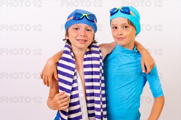 Siblings dressed and hugging in their swimsuits for swimming lessons in the pool. White background