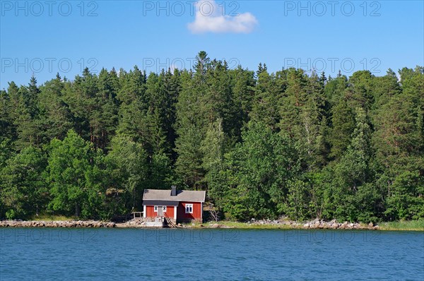 Small red cottage on the shore of the Baltic Sea