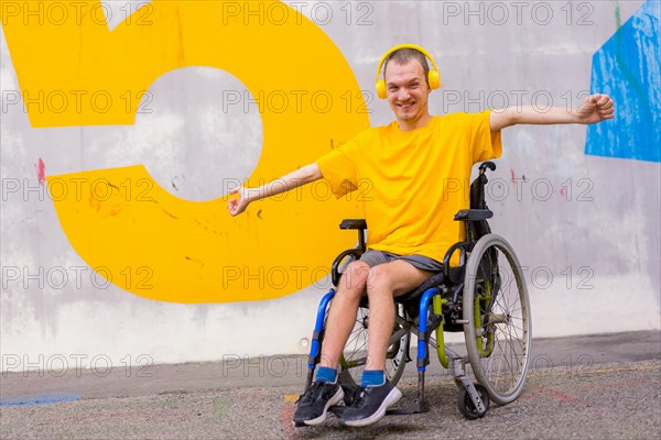 Disabled person in wheelchair listening to music on headphones