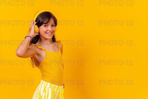 A girl listening to music and dancing with wireless headphones music streaming or online