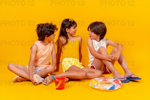 Portraits of children sitting on the floor enjoying holidays with toys