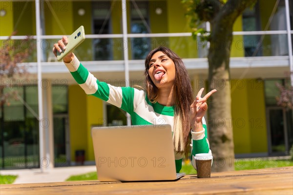 Portrait of a caucasian girl working with a computer in nature