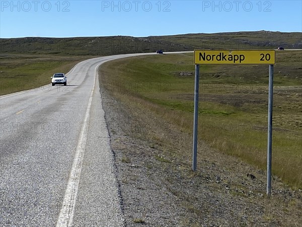 Signpost on a straight road